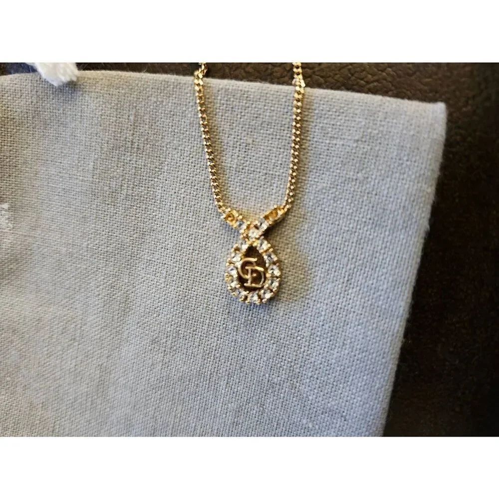 Dior necklace Gold Toned. Missing 2 stones at the top of each side.